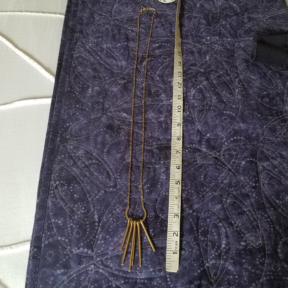 Long gold tone necklace with hanging bars